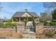Community clubhouse with brick accents, manicured landscaping, and a welcoming entrance staircase at 605 Camano Way, Mcdonough, GA 30253