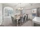 Elegant dining room with coffered ceilings, large table, and decorative chandelier at 605 Camano Way, Mcdonough, GA 30253