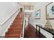 Entry way with wood stairs, hardwood floors, a decorative table, and an upstairs landing at 605 Camano Way, Mcdonough, GA 30253