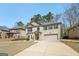 Charming two-story brick home with a manicured lawn and two car garage at 605 Camano Way, Mcdonough, GA 30253