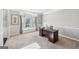 Bright home office with large window seat and a dark wood desk at 605 Camano Way, Mcdonough, GA 30253