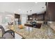 Kitchen featuring granite countertops, a large island with seating, and stainless steel appliances at 605 Camano Way, Mcdonough, GA 30253