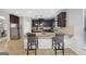 Spacious kitchen with a large island, granite countertops, dark wood cabinets and bar stool seating at 605 Camano Way, Mcdonough, GA 30253
