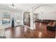 Open concept living area with hardwood floors, white columns, and a view to the kitchen at 605 Camano Way, Mcdonough, GA 30253