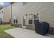 Close-up of the backyard patio featuring a grill, lush grass and access to the back door at 2458 Walker Dr, Hampton, GA 30228