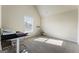Bright bedroom with ample sunlight, featuring neutral tones, carpet, desk, and exercise bike at 2458 Walker Dr, Hampton, GA 30228