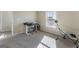 Bright bedroom featuring neutral tones, desk, exercise equipment, and ample sunlight from window at 2458 Walker Dr, Hampton, GA 30228