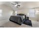 Spacious bedroom featuring a ceiling fan, plush carpet, and ample natural light at 2458 Walker Dr, Hampton, GA 30228
