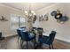 Bright dining room features a chandelier, modern decor, and a glass table at 2458 Walker Dr, Hampton, GA 30228