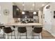Kitchen features granite countertops, stainless appliances, breakfast bar, and dark wood cabinets at 2458 Walker Dr, Hampton, GA 30228