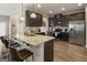 Spacious kitchen features a breakfast bar, stainless appliances, and dark cabinets at 2458 Walker Dr, Hampton, GA 30228