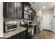 Updated kitchen featuring granite countertops, stainless steel appliances, and modern fixtures at 2458 Walker Dr, Hampton, GA 30228
