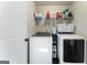 Functional laundry room featuring modern washer and dryer, shelving, and ample storage space at 2458 Walker Dr, Hampton, GA 30228