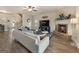 Inviting living room features a fireplace, ceiling fan, and stairs to the second level at 2458 Walker Dr, Hampton, GA 30228
