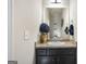 Well-lit powder room with a dark vanity, granite countertop, and decorative accents at 2458 Walker Dr, Hampton, GA 30228
