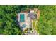 Aerial view of a pool and recreation area surrounded by lush greenery and a clubhouse at 8110 Brewton Bnd, Cumming, GA 30028