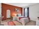 Inviting bedroom featuring warm tones, a stylish mirror, and a comfortable bed bathed in natural light at 8110 Brewton Bnd, Cumming, GA 30028