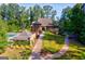 A luxurious clubhouse features a swimming pool, beautifully landscaped grounds, and a stone exterior at 8110 Brewton Bnd, Cumming, GA 30028