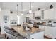 Modern kitchen featuring white cabinetry, granite countertops, stainless steel appliances, and a large island with seating at 8110 Brewton Bnd, Cumming, GA 30028