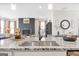 Open-concept kitchen boasting granite counters, stainless steel sink, and views into the living area with a fireplace at 8110 Brewton Bnd, Cumming, GA 30028