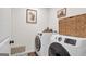 Efficient laundry room features a side-by-side washer and dryer, as well as ample storage at 8110 Brewton Bnd, Cumming, GA 30028