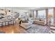 Inviting living room with hardwood floors, a comfortable sectional sofa, and large windows offering natural light at 8110 Brewton Bnd, Cumming, GA 30028