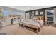 Stylish main bedroom with large windows, a wooden bed frame, and a cozy bench at 8110 Brewton Bnd, Cumming, GA 30028
