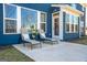 Relaxing patio area with lounge chairs, a small table, and a beautifully designed exterior at 8110 Brewton Bnd, Cumming, GA 30028