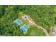 Aerial view of community tennis courts surrounded by lush trees, offering a serene recreational space at 8110 Brewton Bnd, Cumming, GA 30028