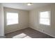 Bright bedroom features neutral paint, carpet, two windows and base trim at 5784 Sharon Dr, Norcross, GA 30071
