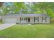 Charming single-story home with a well-manicured lawn and inviting front porch at 5784 Sharon Dr, Norcross, GA 30071