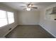 Bright living room with large window and ceiling fan, open to the kitchen at 5784 Sharon Dr, Norcross, GA 30071