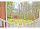 View of the backyard from steps showing well-maintained lawn and trees at 165 Hideaway Dr, Fayetteville, GA 30215