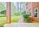 Lush backyard showcasing a brick home with a manicured lawn and a charming brick pathway at 165 Hideaway Dr, Fayetteville, GA 30215