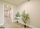 Basement hallway with tile flooring, open doors, and decor plants at 165 Hideaway Dr, Fayetteville, GA 30215