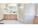 Bathroom featuring light colored cabinets, glass shower, tile floor, and a large mirror at 165 Hideaway Dr, Fayetteville, GA 30215