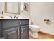 Bathroom with a blue vanity, white countertop, and gold fixtures at 165 Hideaway Dr, Fayetteville, GA 30215