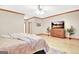 Bedroom features wood flooring, wood trim, and dresser with a TV at 165 Hideaway Dr, Fayetteville, GA 30215