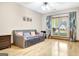 Cozy bedroom features hardwood floors, leafy curtains, and large bright windows at 165 Hideaway Dr, Fayetteville, GA 30215