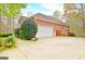 Charming brick home with a two-car garage, mature landscaping, and an inviting driveway at 165 Hideaway Dr, Fayetteville, GA 30215