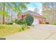 Brick home with attached garage, concrete driveway, and manicured landscaping at 165 Hideaway Dr, Fayetteville, GA 30215