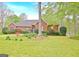 A charming brick home with well-manicured lawn and mature landscaping at 165 Hideaway Dr, Fayetteville, GA 30215