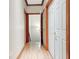 Hallway with hardwood flooring and multiple doors leading to other rooms at 165 Hideaway Dr, Fayetteville, GA 30215