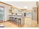 Bright kitchen features hardwood floors, bar seating and stainless steel appliances at 165 Hideaway Dr, Fayetteville, GA 30215