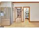 Open kitchen featuring stainless steel fridge, access to hall, and a pantry at 165 Hideaway Dr, Fayetteville, GA 30215
