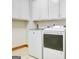 Laundry room featuring a modern, white washer and dryer set at 165 Hideaway Dr, Fayetteville, GA 30215