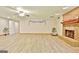 The spacious living area has a ceiling fan, fireplace, and neutral paint at 165 Hideaway Dr, Fayetteville, GA 30215