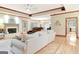 Open-concept living area boasts hardwood floors, a fireplace, and seamless flow into other living spaces at 165 Hideaway Dr, Fayetteville, GA 30215