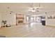 Spacious living room features brick fireplace, neutral paint, wood flooring and access to kitchen area at 165 Hideaway Dr, Fayetteville, GA 30215
