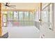 Screened porch with ceiling fan and view of trees at 165 Hideaway Dr, Fayetteville, GA 30215
